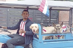 Joven recorre Ypacaraí paseando perros en un motocarro